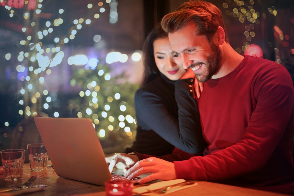 happy-couple-watching-laptop-together