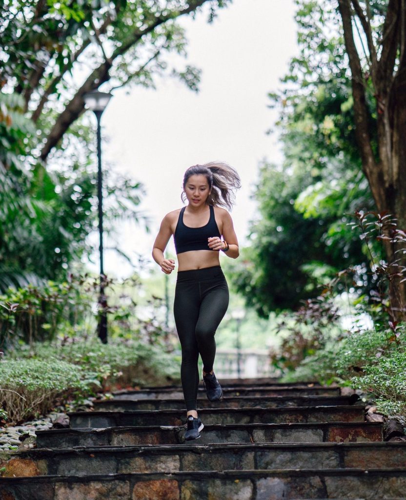 Woman running down stairs to become fit and to reach full potential
